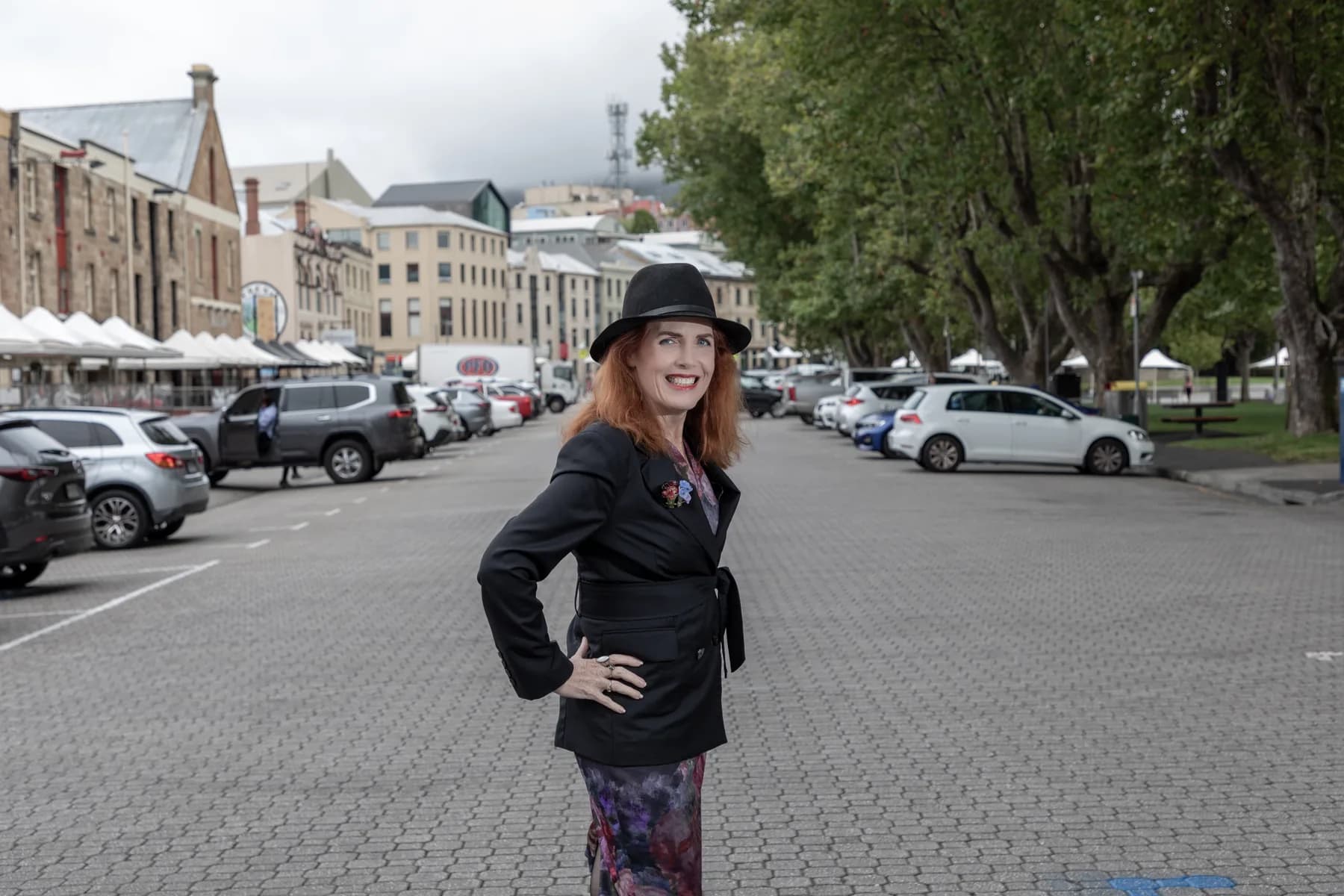 Louise Bloomfield in Salamanca Place, Hobart, with the city and kunanyi behind her